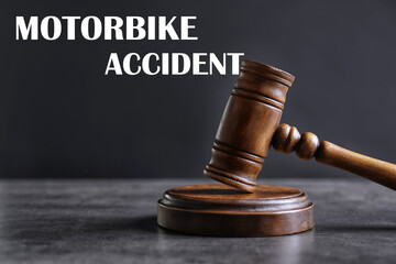 Motorbike accident law. Judge's gavel on grey table