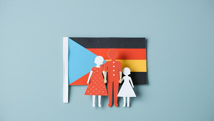 Family figure made of paper on polyamory flag