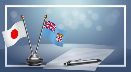 Japan and Fiji Small national flag on bokeh background, cooperative relationship