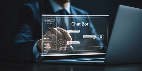 Chatbot technology implementation: A businessman configures a chatbot interface on a laptop, demonstrating the integration of AI-driven customer service solutions.
