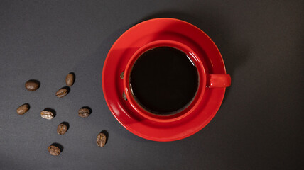 Above Isolated Red Coffee Cup with brown coffee beans in Black background