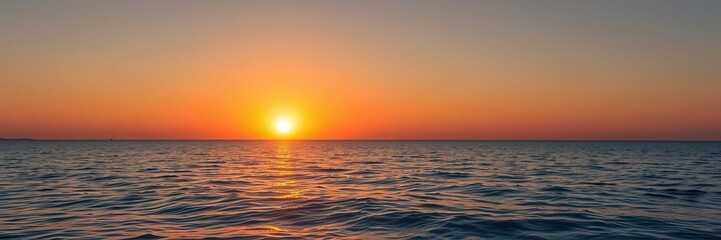 Fototapeta premium The sun sets over the horizon casting a warm golden light on the crystal clear sea, serene landscape, clear water
