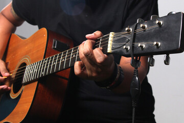 Close up shot hands of guitarist perform with his acoustic guitar