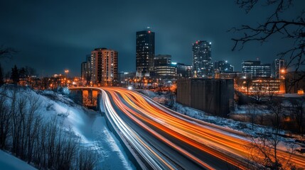 Fototapeta premium Night cityscape with highway traffic and snow.