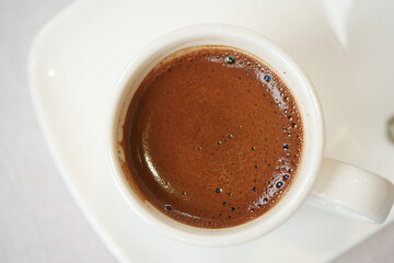 A CloseUp Image of a Traditional Coffee Cup That is Filled with Rich, Dark Brew