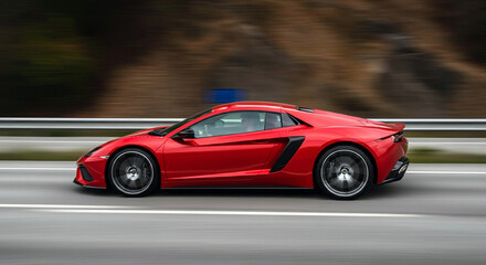 Obraz premium Red Sports Car in Motion on the Highway