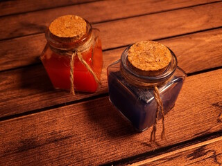 Health and mana potions on a wooden table, as decoration for a medieval fantasy atmosphere
