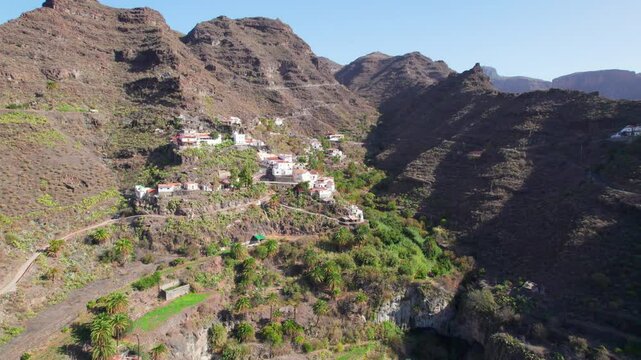 Exploring the Charm of Carrizal de Tejeda on the Island of Gran Canaria from Above on a Sunny Day with Majestic Volcanic Mountains