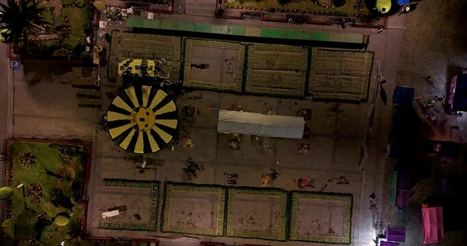Aerial shot in Hyperlapse showing the placement of flowers for the pre-Hispanic-themed Day of the Dead altars at night, set up in the main square of Tepotzotl&aacute;n, Mexico
