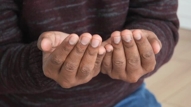 muslim man keep hand in praying gestures during ramadan, Close up 