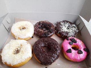 display of donuts of various flavors on cardboard. business background concepts, food recipes,...