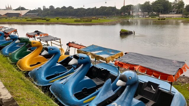 photo of the duck boat ride in the morning at tmii (taman mini indonesia indah). the background concept of recreational parks, cultural heritage, rides for playing and learning, filling vacation time