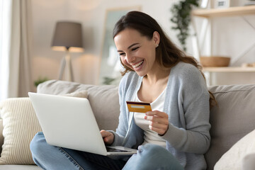 Fototapeta premium Happy woman using a credit card and laptop for online shopping at home - Shopping online concept