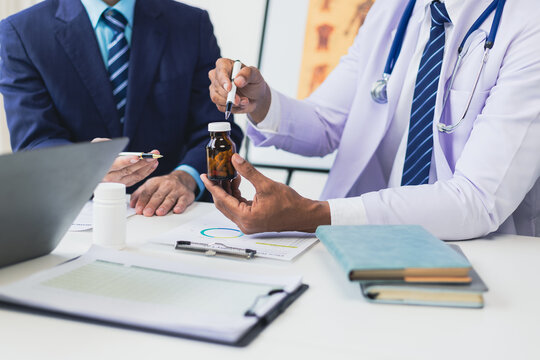 Group meeting of medical experts team is discussing the results of new drug treatments for patients. Healthcare staff discussing statistics, results of research and innovation. - Powered by Adobe