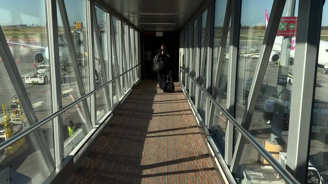 Passenger POV boarding plane inside airplane bridge. Person entering aircraft