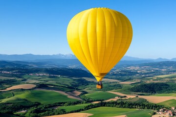 Obraz premium Balloon air gliding over a patchwork of colorful farmlands, with the horizon stretching far and wide