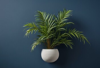 Obraz premium Minimalist Ceramic Pot With Green Palm Plant Against Deep Blue Background