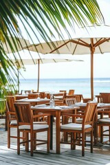 Fototapeta premium Beachfront restaurant with wooden tables and chairs.