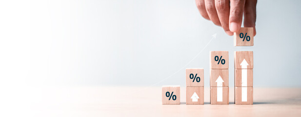 Interest rate and dividend concept, wooden block with percentage symbol and up arrow, return on...
