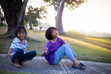 Two Girls on a Playing Field Hugging