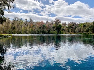 Fototapeta premium Lake view with surface reflections and bright sky