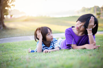 Two Girls on a Playing Field Hugging