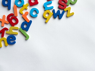 Colorful alphabet letters scattered on white background for education and learning concepts