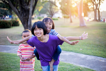 group of cute asian kids having fun in the park