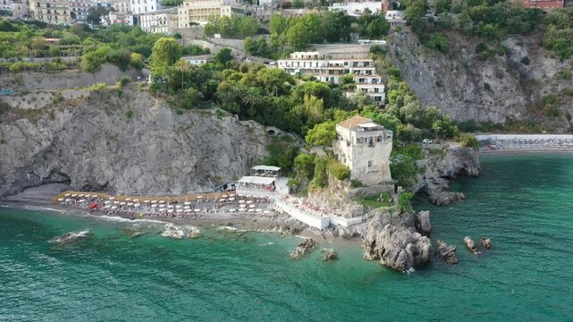 Aerial view of rocky coastline and beach of Vietri Sul Mare on a sunny summer day, Raite, Salerno, Italy