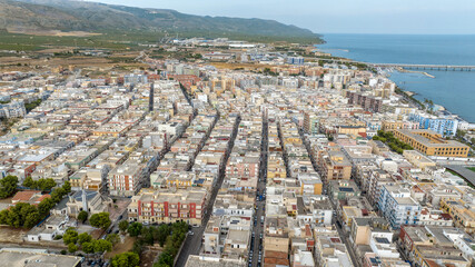 Obraz premium Aerial view of houses, buildings, apartments and roof of Manfredonia, in the province of Foggia, in Puglia, Italy. It is a town on Mediterranean sea.