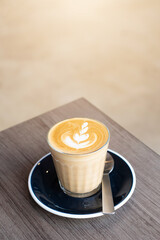 hot latte art in white cup on black background.