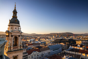 Obraz premium Budapest from above during sunset, view from Saint Stephen Cathedral. Travel to Hungary. Beautiful sunset over Budapest.