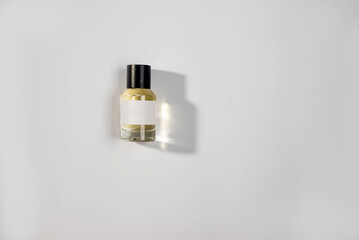 sleek perfume bottle with a black cap, set against a white background. The clean lines and elegant...