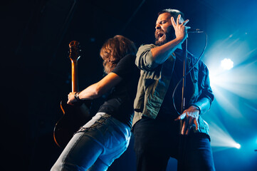 Rock band performing live on stage with passion and energy