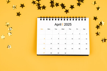 April 2025 calendar and scattered sparkling yellow confetti stars.