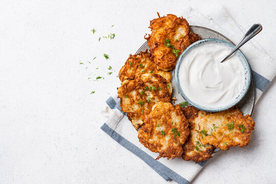 Potato latkes with sour cream. Hash browns.