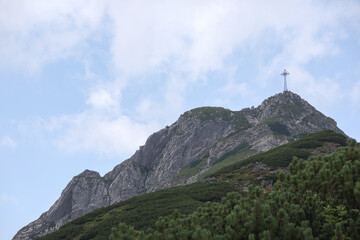 Fototapeta premium Natural landscape in the mountains, one of which has a cross