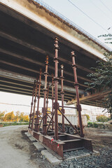 work to maintenance a bridge over highway. old automotive bridge repair process with scaffolds and supporting constructions. Chisinau, Moldova, 2024.
