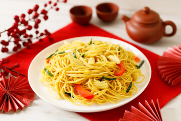 Chinese Lunar New Year concept with lucky food longevity noodles on wooden table background.