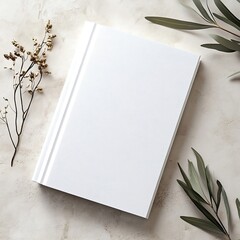 Elegant white hardcover journal mockup on a marble surface, accompanied by dried wheat stems, showcasing a minimalist and natural aesthetic.