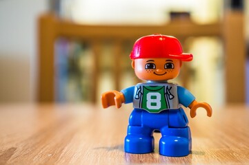 Naklejka premium Lego Duplo child figurine on a table.