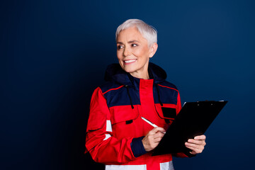 Photo of retired female ambulance doctor specialist paperholder look empty space wear red uniform...