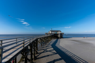 Laufsteg mit Pfahlbau am Strand von Sankt Peter Ording.