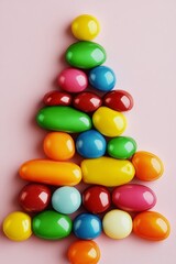 Obraz premium Colorful candy tree made of various colored candies. The candies are arranged in a pyramid shape, with the top candy being the largest and the bottom candy being the smallest