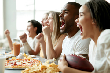 Friends watching Super Bowl football game eating snacks together at home