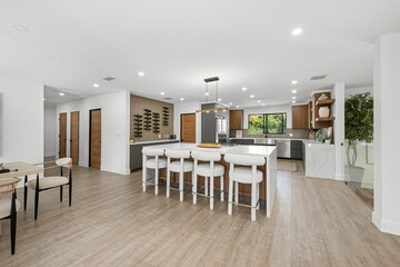 Modern kitchen with wooden accents and island seating.