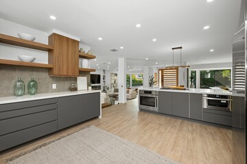 Modern kitchen with sleek cabinets and bright lighting.