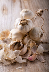braid and garlic cloves on a rustic wooden board.