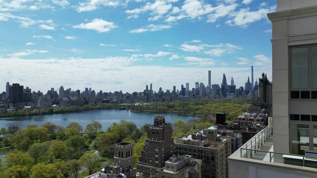 A drone captures a stunning side-tracking shot of West 96th Street, New York City, showcasing the urban landscape and street traffic in horizontal orientation. Ideal for cityscape and travel footage.