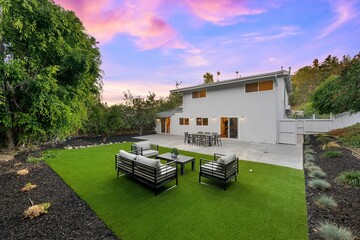 Modern backyard with vibrant sunset sky.